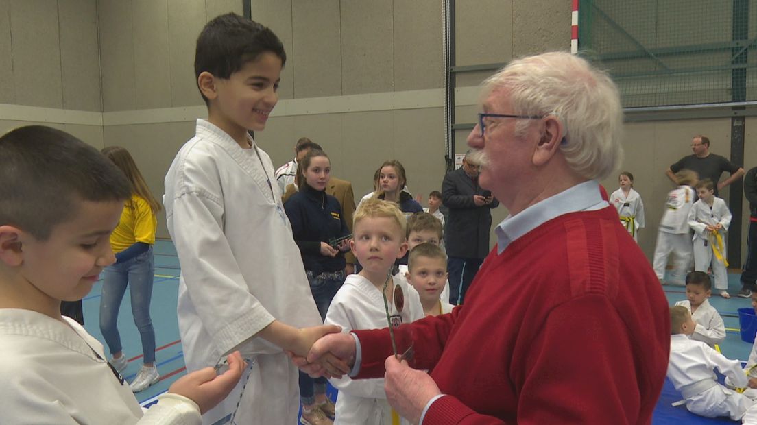 Gerrit Eissink feliciteert een jonge Taekwondo-kampioen