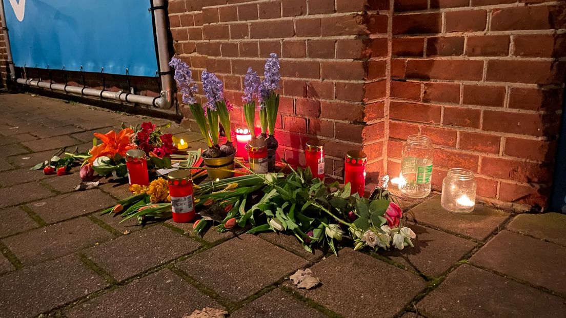 Voor de raadszaal liggen bloemen en branden kaarsjes