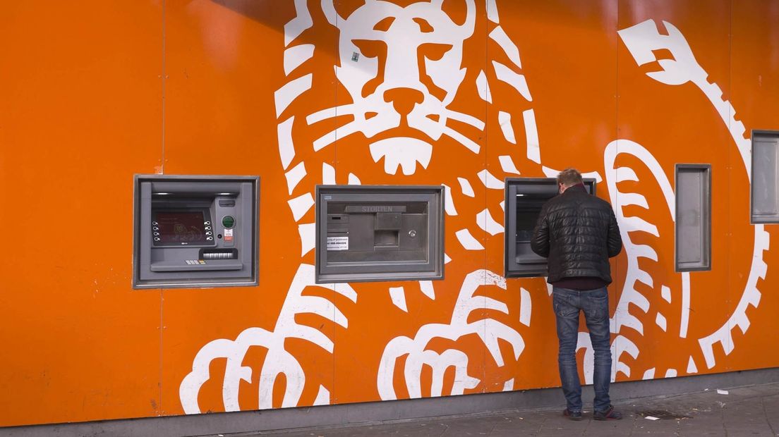 Iemand pint bij een geldautomaat