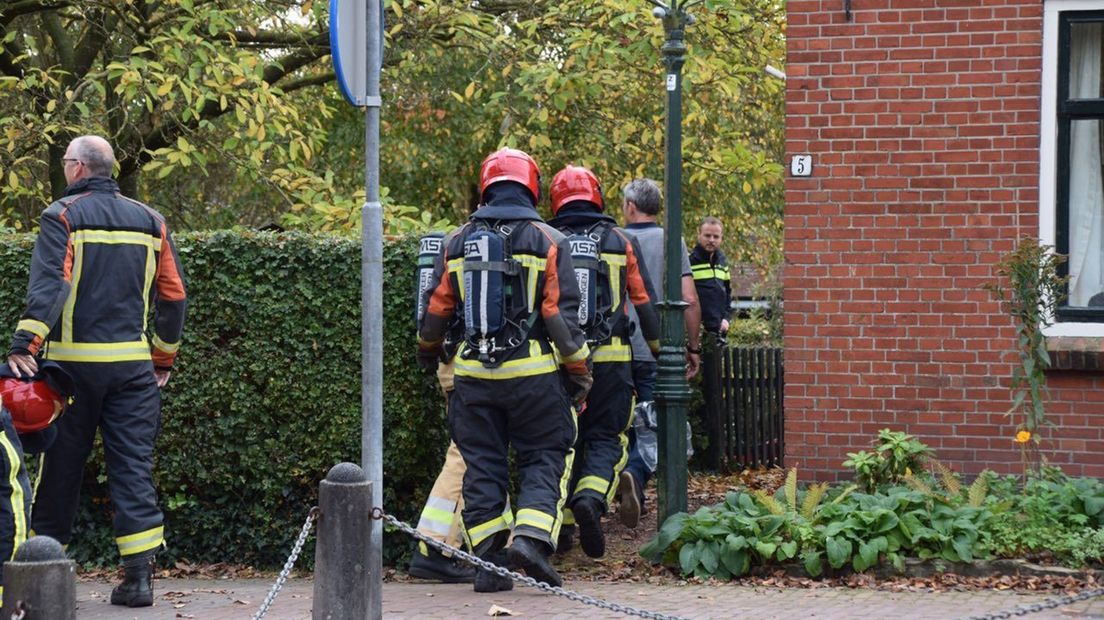 De brandweer arriveert bij de woning aan de Hofstraat in Aduard.