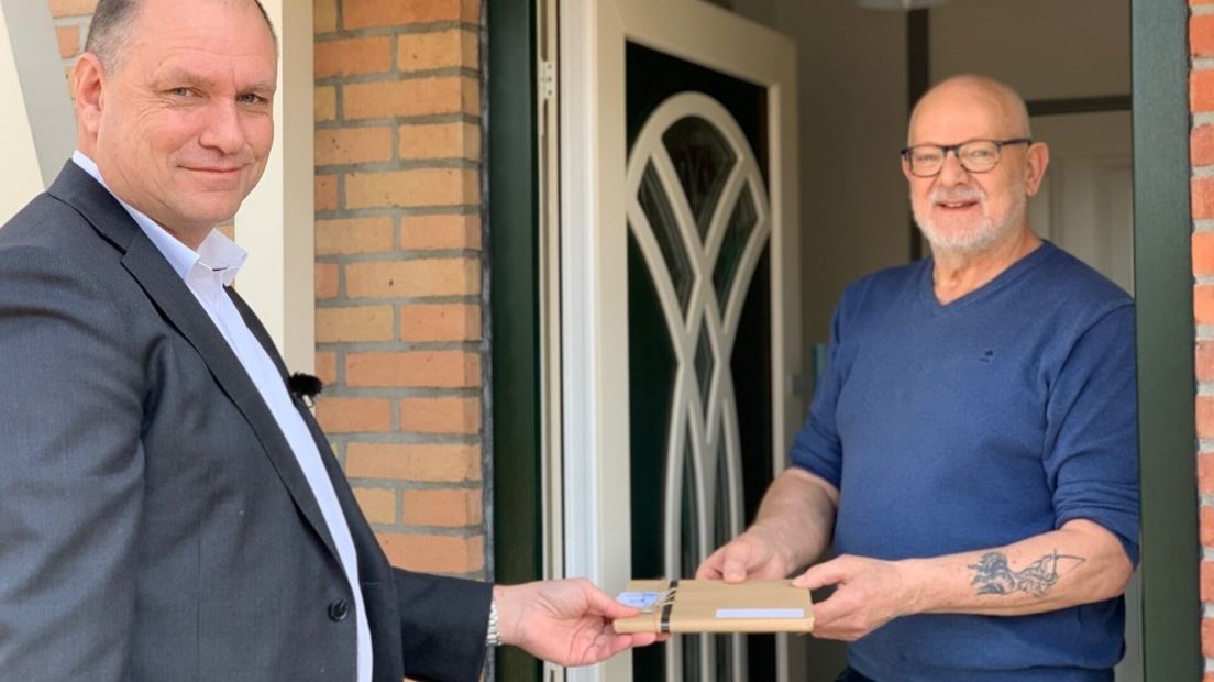 wethouder Kees Verburg overhandigde een van de boekjes aan mantelzorger Rinus Eckhardt