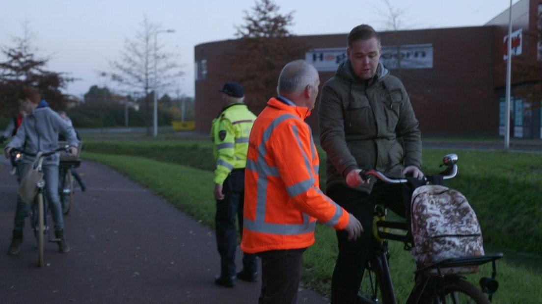 Gedeputeerde Brink controleert fietsers op hun verlichting (Rechten: RTV Drenthe)