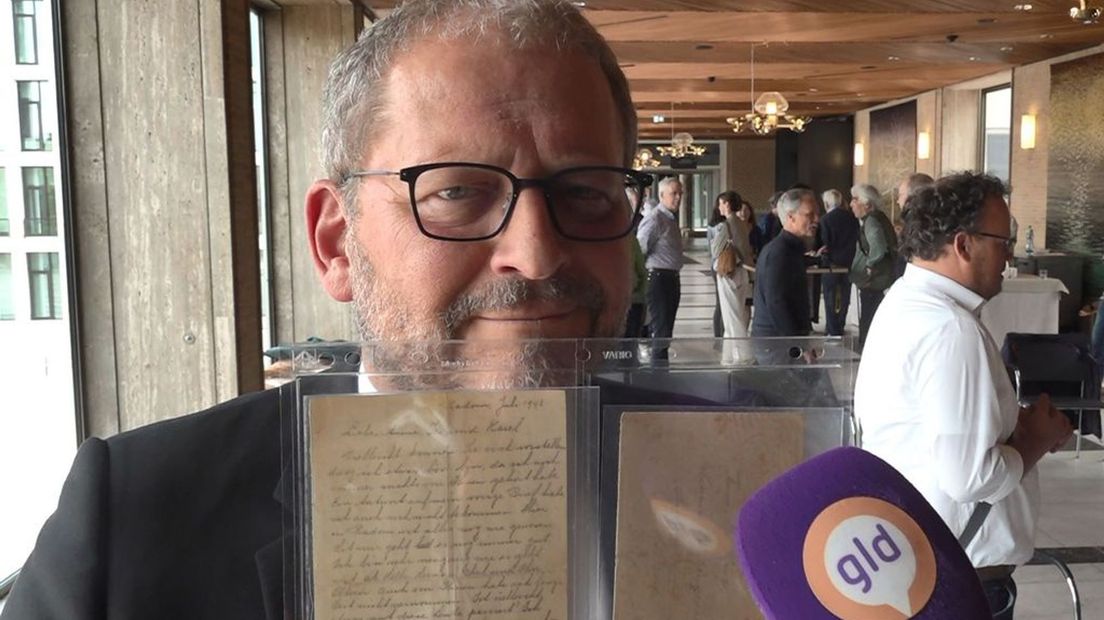 Museumdirecteur Emile Schrijver toont de brief van Jules Schelvis die hij zojuist overhandigd heeft gekregen.