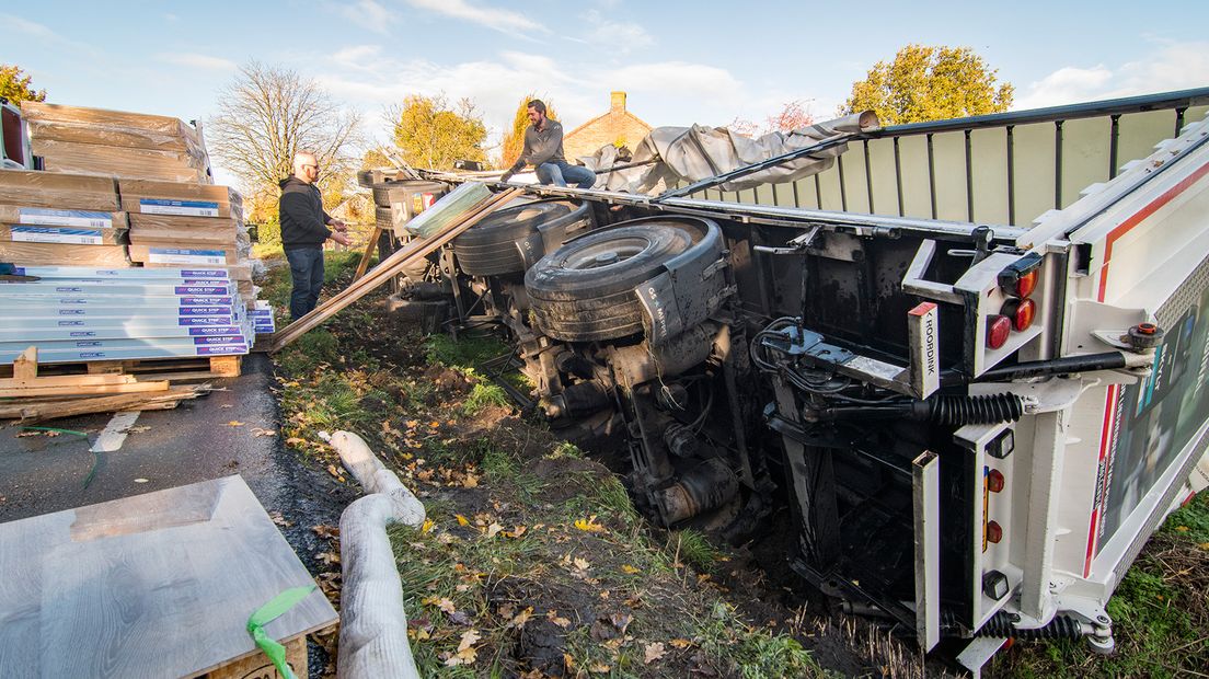 Een grote partij kliklaminaat wordt uit de vrachtwagen getakeld.