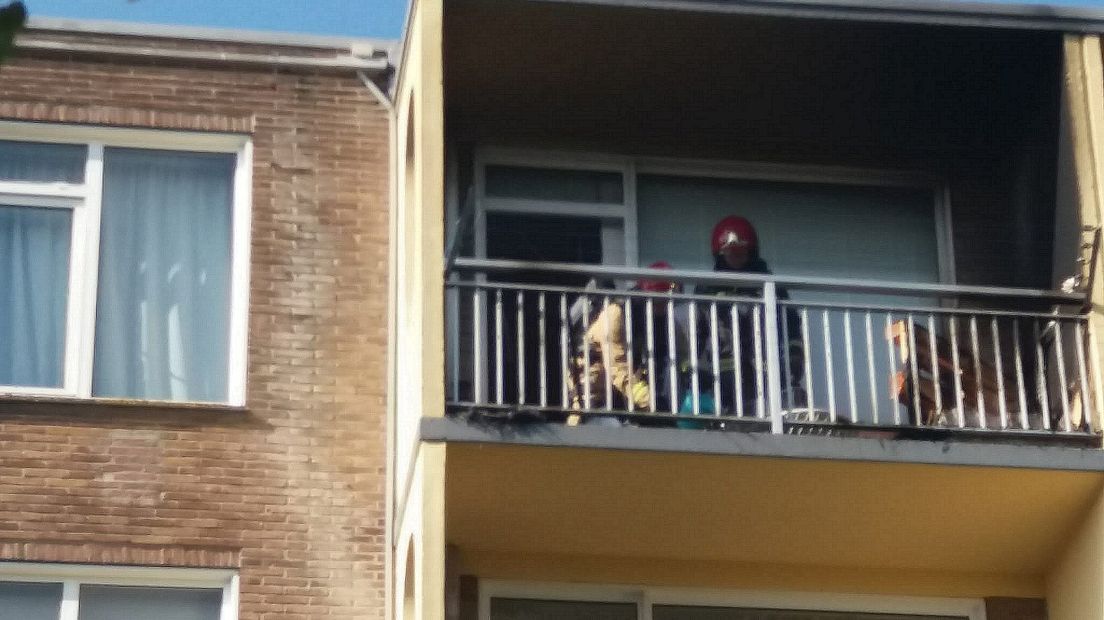 Firefighters extinguish the balcony fire