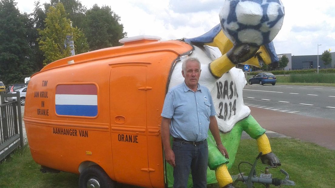Jan Krul bij zijn oranje caravan