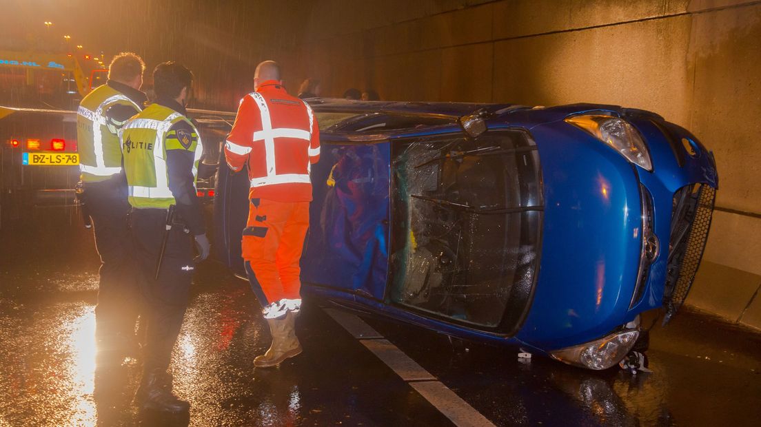 Auto op zijn kant door enorme plas water in Nieuwerkerk aan den IJssel Omroep West