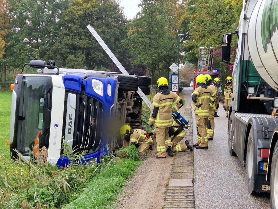 Firefighters check the overturned body truck