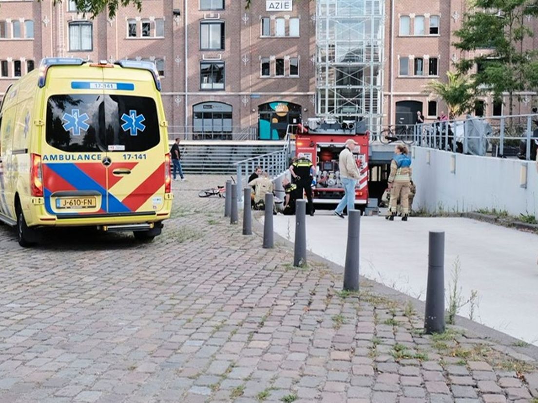 Ambulance en brandweer zijn ter plaatse om het kind dat vastzit tussen de garagedeur aan het Handelsplein te Rotterdam-Zuid te bevrijden