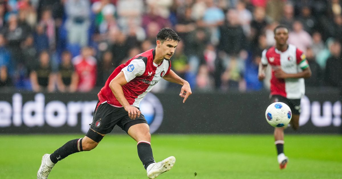 A 19-year-old professional footballer in Feyenoord training gear looking focused during a preseason match.