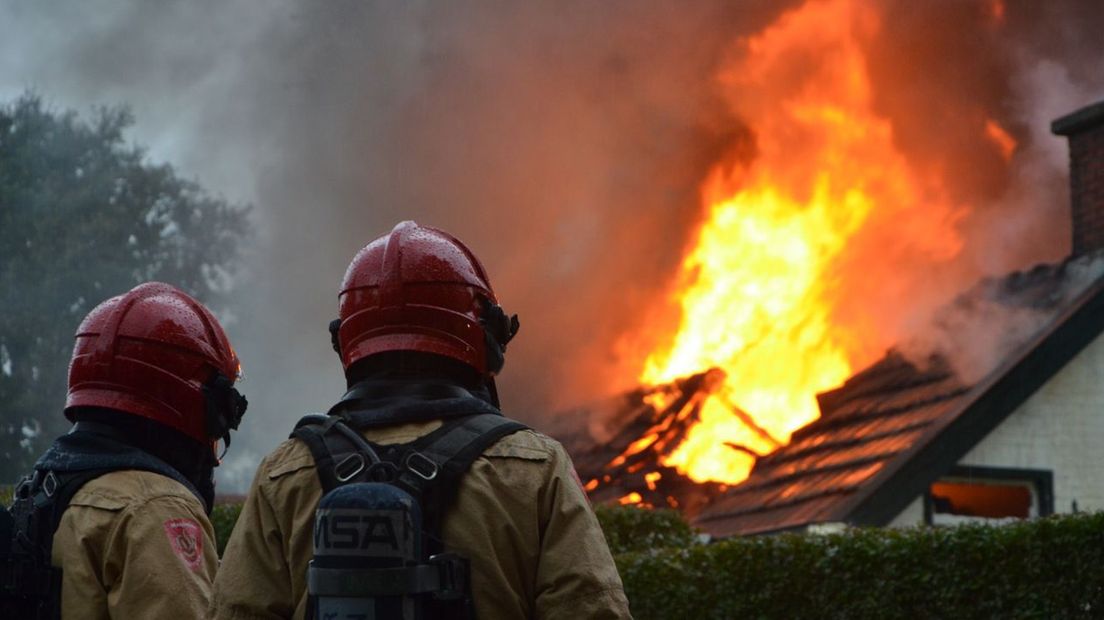 Brandweermannen kijken machteloos toe, bij een brand in Westerlee, vorige week
