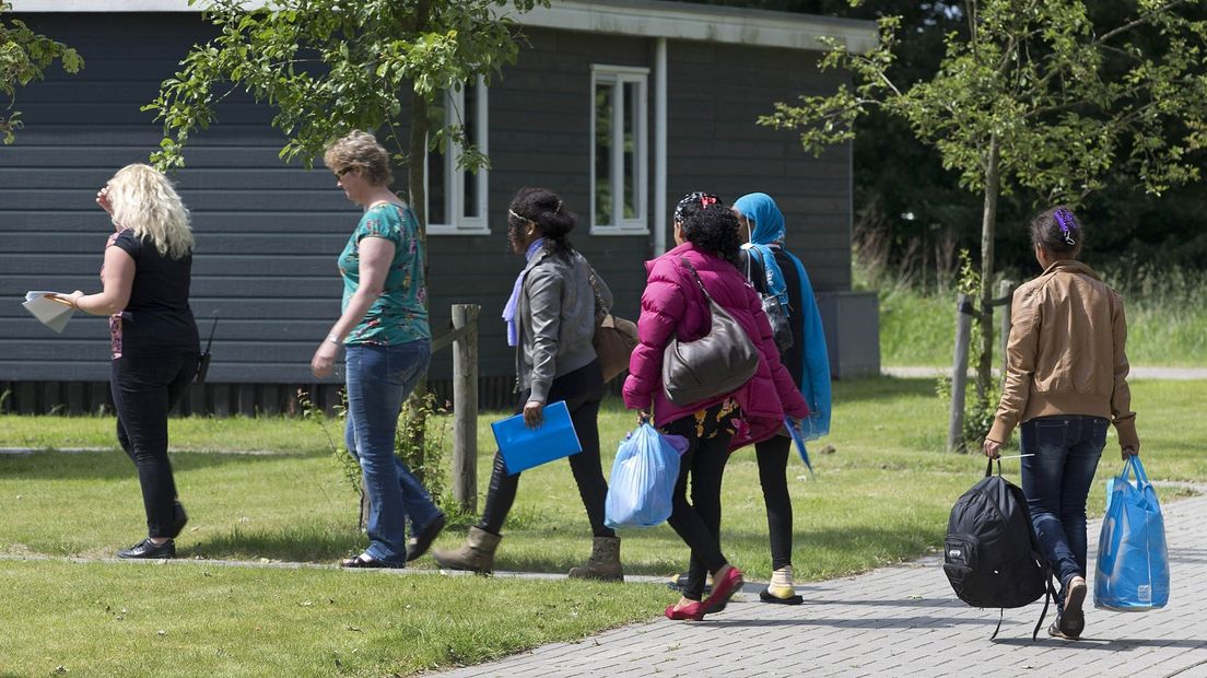Vluchtelingen arriveren bij het azc Onnen