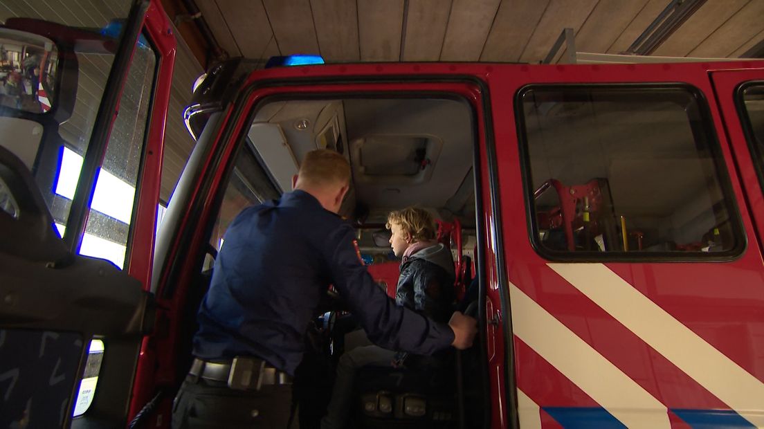 Thijs mag kijken in de brandweerwagen.