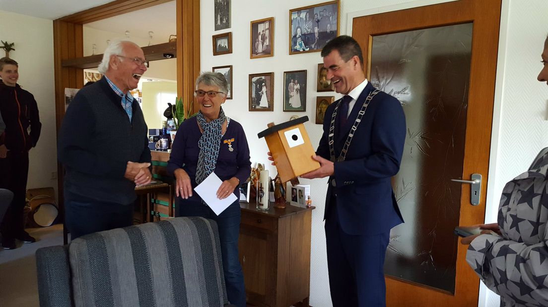 Ali Odijk uit Schalkwijk werd Lid in de Orde van Oranje-Nassau en verraste burgemeester De Jong van Houten met een zelfgemaakt nestkastje voor koolmezen.
