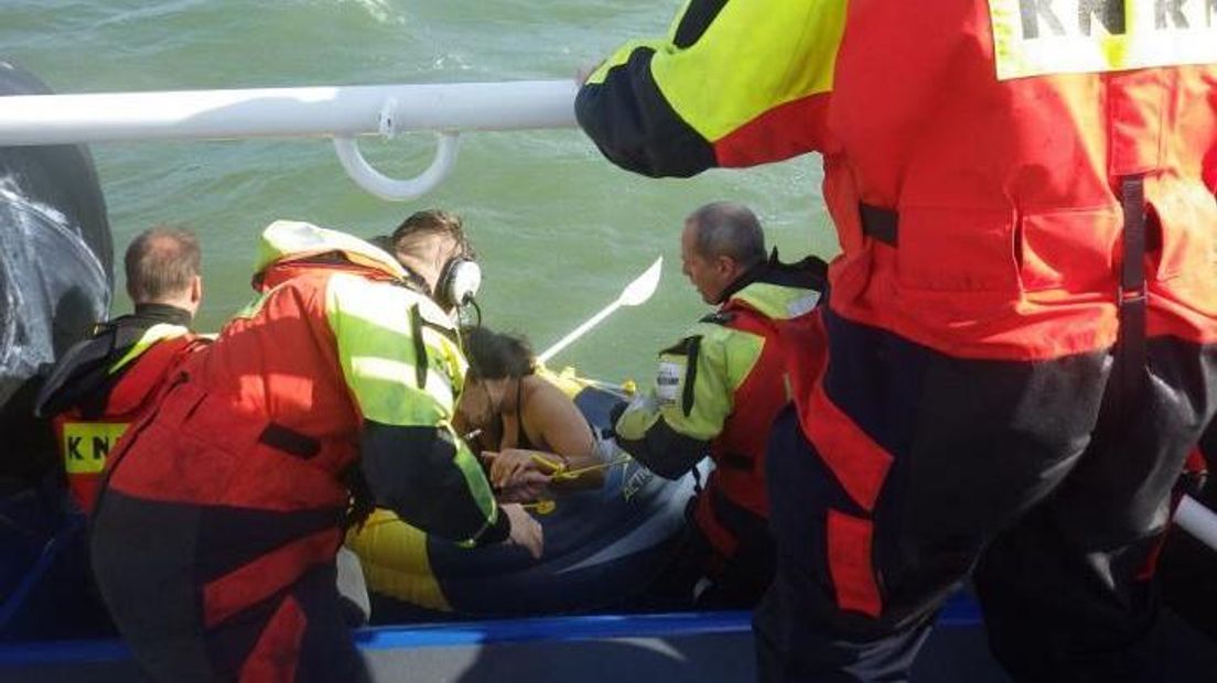 Via de drenkelingenklep worden de meiden en de rubberboot op de reddingsboot gehesen.