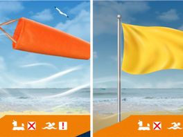 Oranje windzak en gele vlag gehesen op strand vanwege gevaarlijke zee