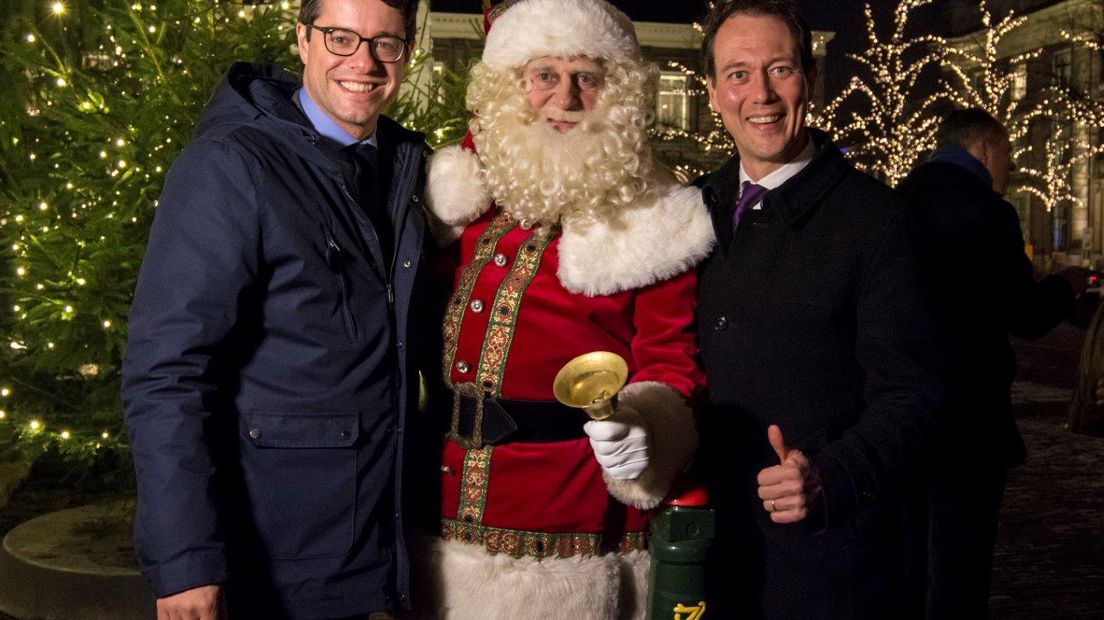 Wethouders Karsten Klein en Boudewijn Revis poseren met de kerstman na het aansteken van de lichtjes 