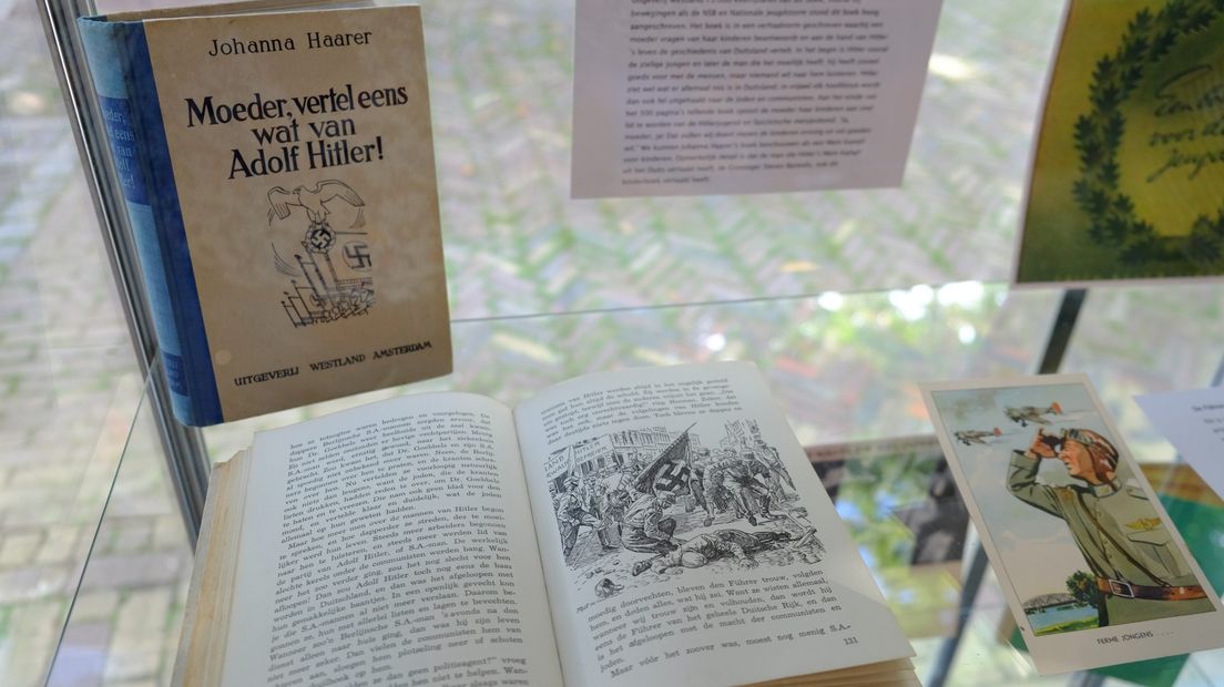 Een vitrinekast met kinderboeken uit de Tweede Wereldoorlog