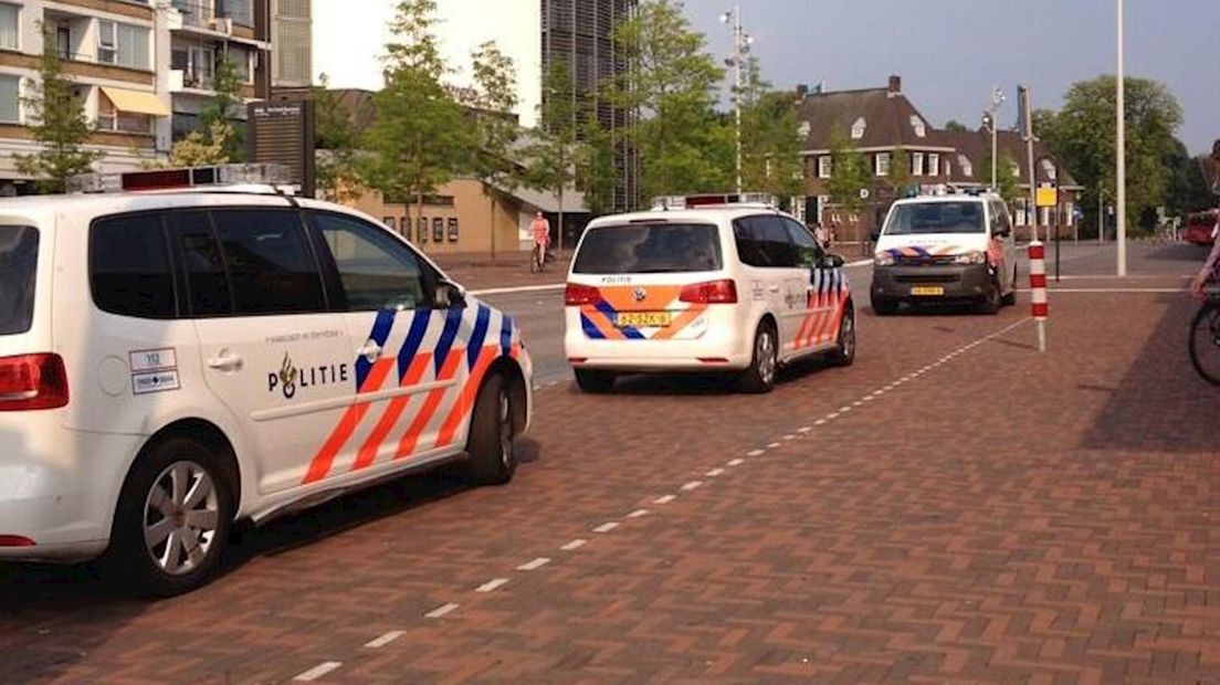 Drie politieauto's bij het station