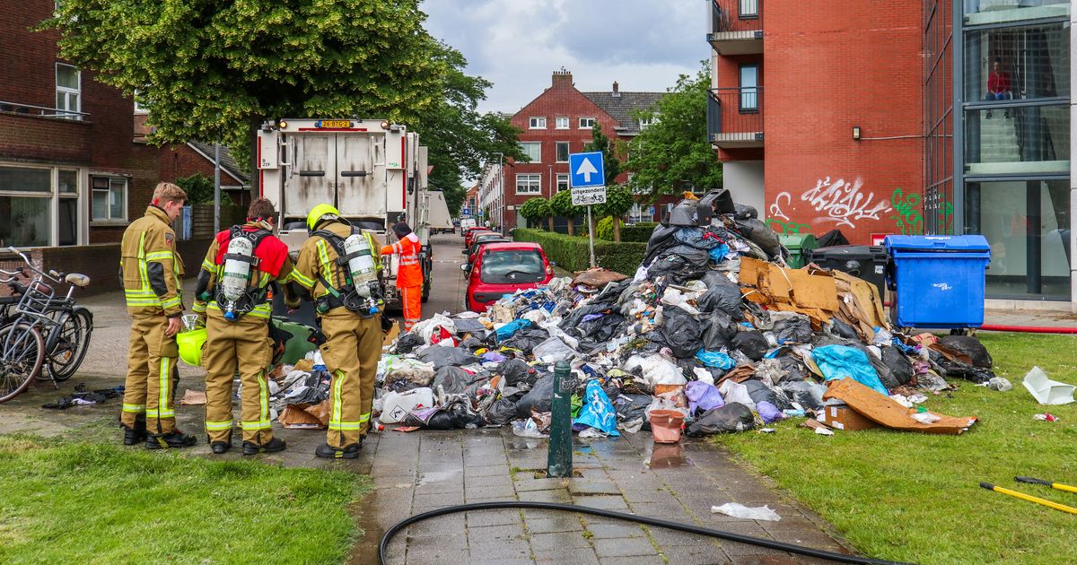 A road affected by garbage as a result of a fireplace in a rubbish truck |  A person with a strolling stick falls on subway tracks