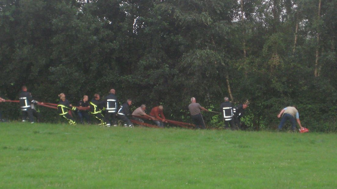 Brandweer probeert paard uit sloot te trekken