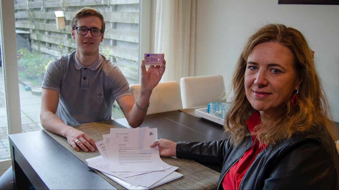 Job Koehorst met z'n rijbewijs en Linda Koehorst tussen de paperassen