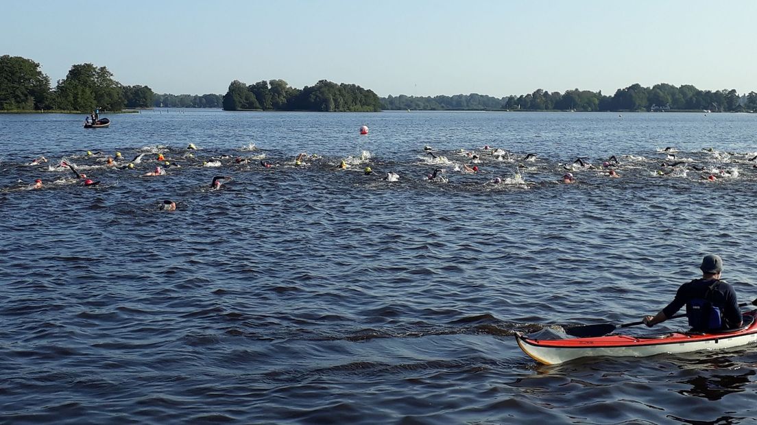 Deelnemers aan de Zwem2Mijl steken het Paterswoldsemeer over