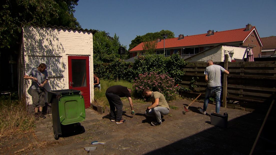 Deelnemers van Stichting Ontmoeting helpen mensen met het onderhoud van hun tuin.