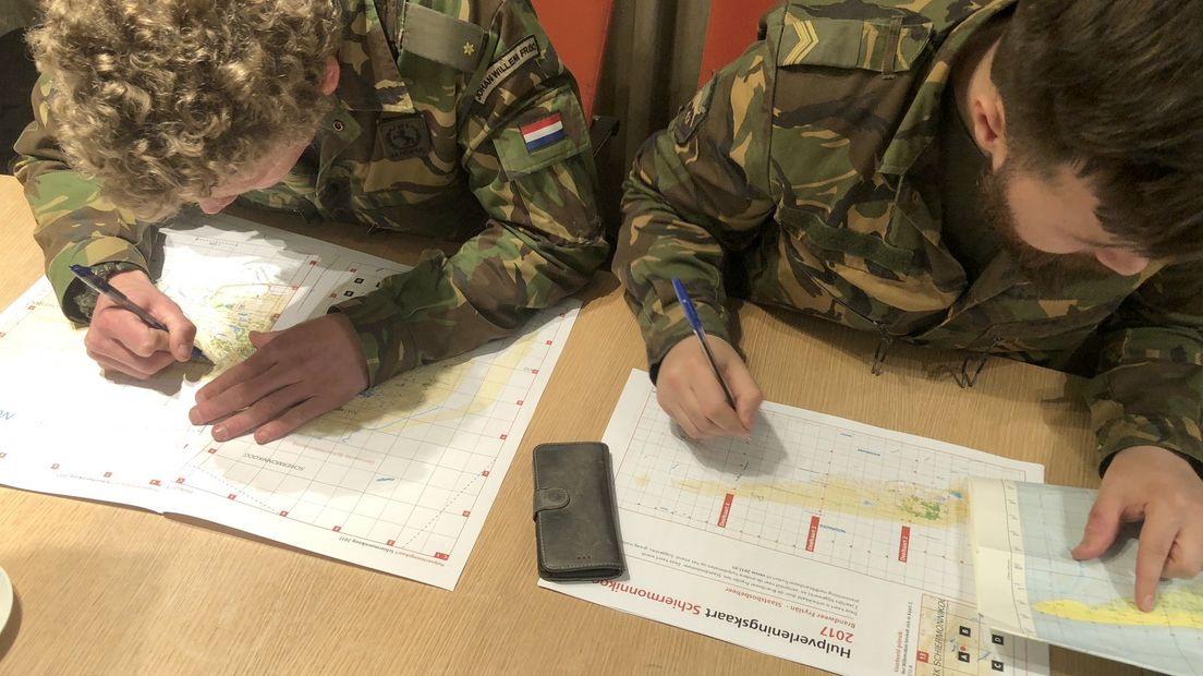 De militairen bestuderen de kaart van Schiermonnikoog.