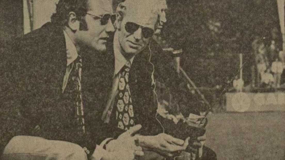 Assistent-trainer Jan Mak (rechts) luistert via een transistorradio naar de tussenstanden