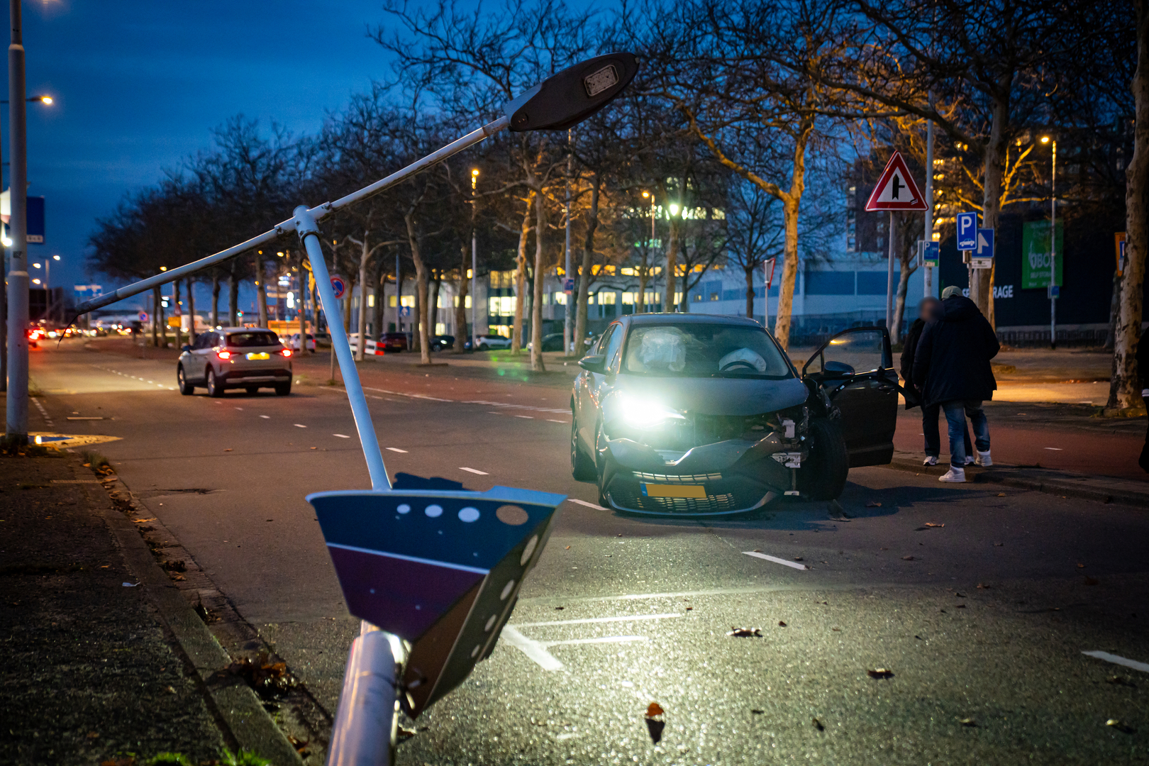 Zowel de lantaarnpaal als de auto liep forse schade op.
