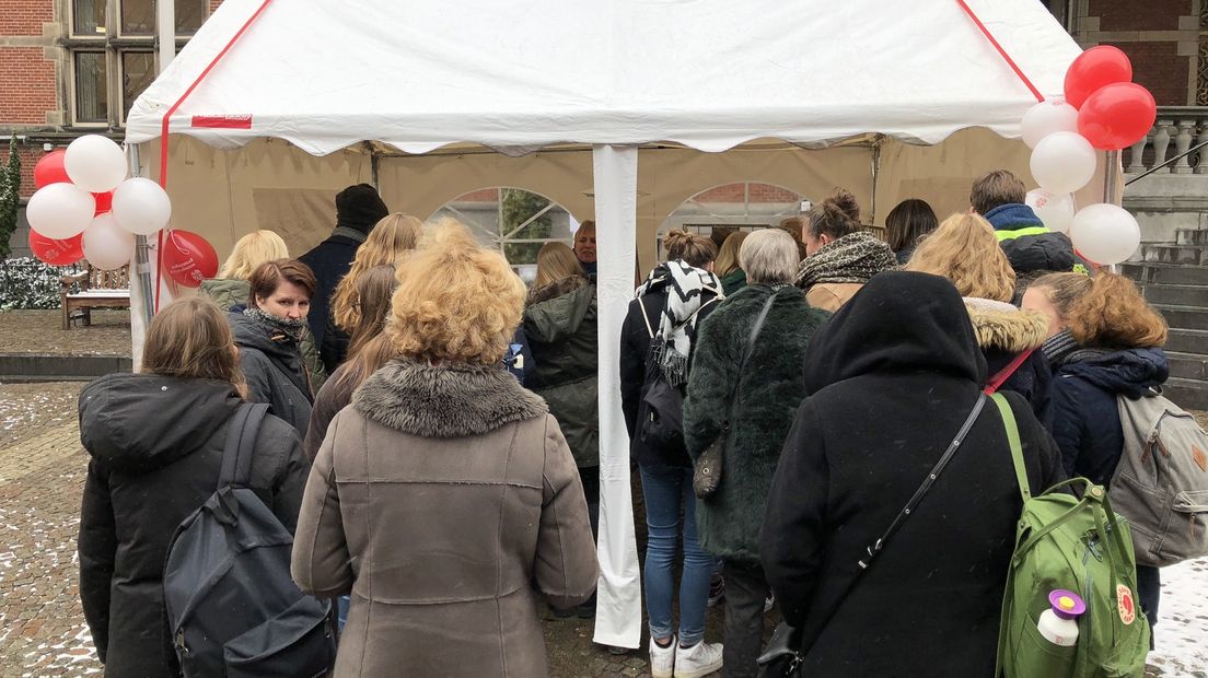 Bij een stand op het Broerplein laten studenten en ouders zich informeren over de open dag