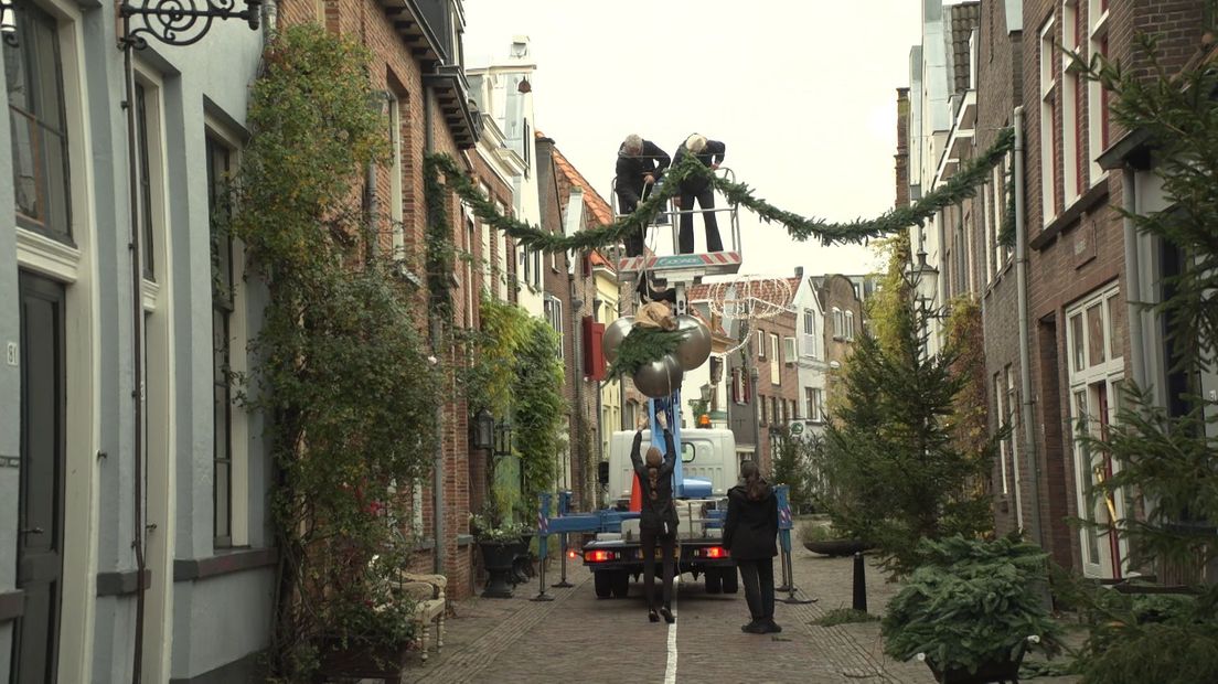 Vrijwilligers hangen kerstdecoratie op in Deventer binnenstad