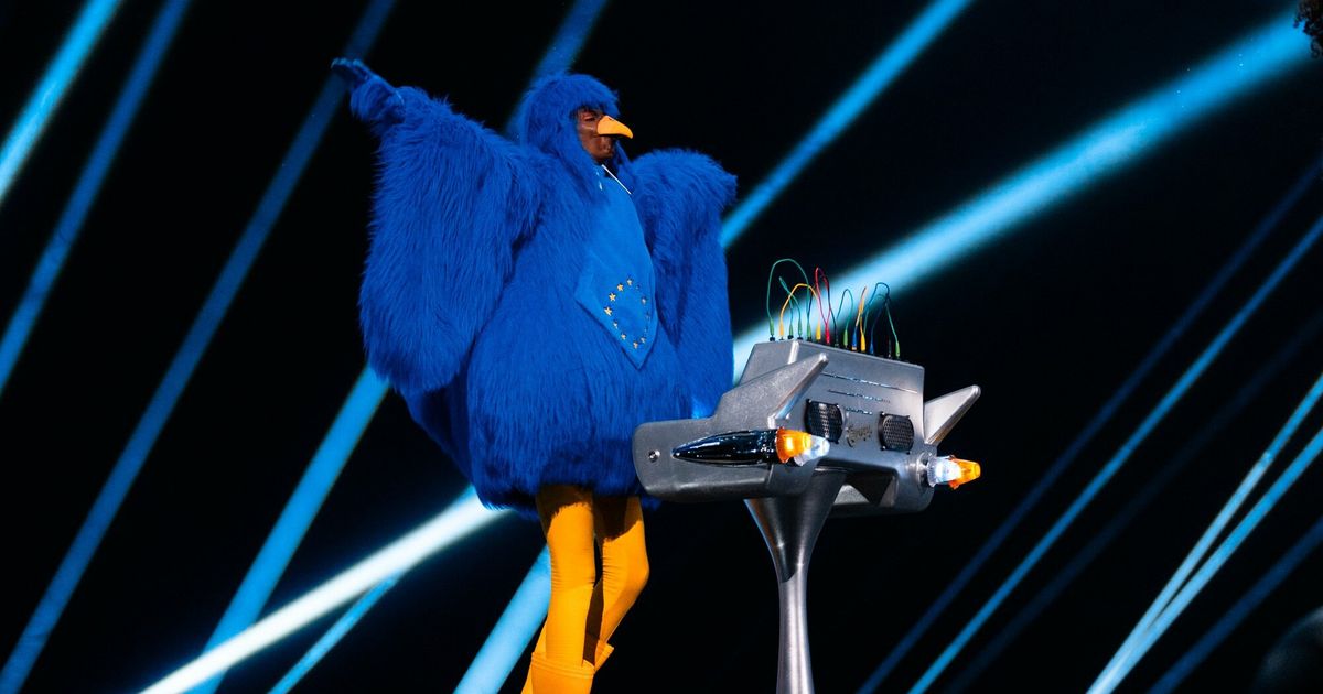 Joost Klein at the Eurovision Song Contest flanked by a large blue bird