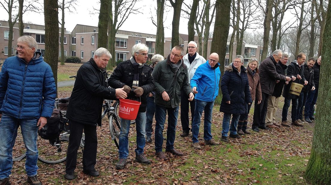 Inwoners geven emmertjes water door om de vijver leeg te halen (Rechten: Jan Pier Cleveringa)