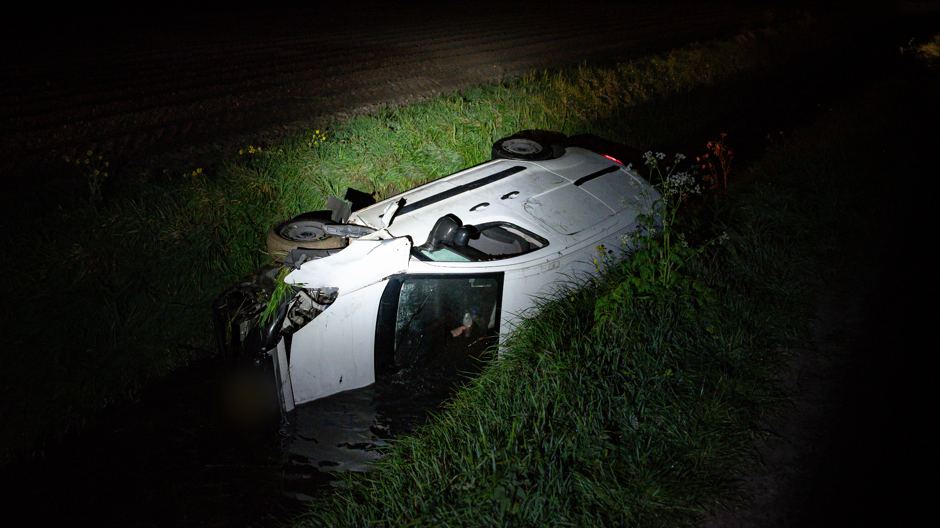 Het bestelbusje kwam op z'n zijkant in de sloot terecht.