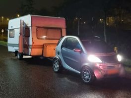 Kleine Smart met fors grotere caravan tuft met 60 km/u over snelweg