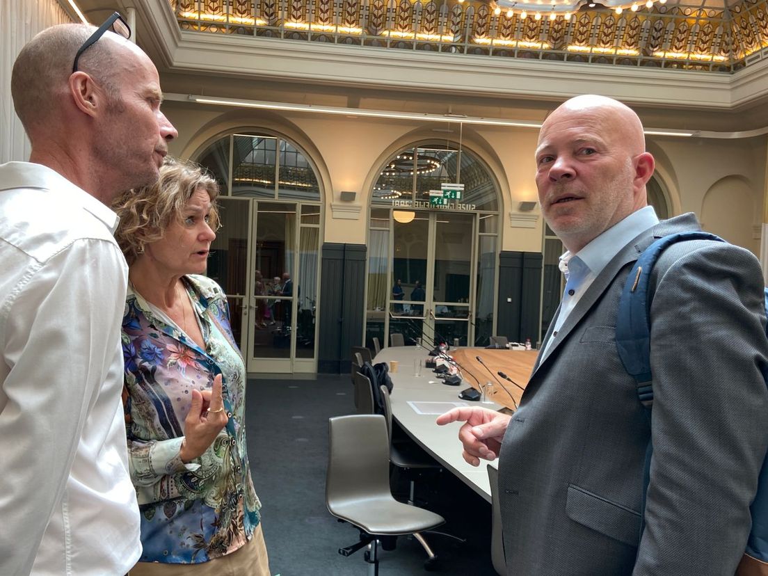 Wethouder Robert Simons praat met twee insprekers