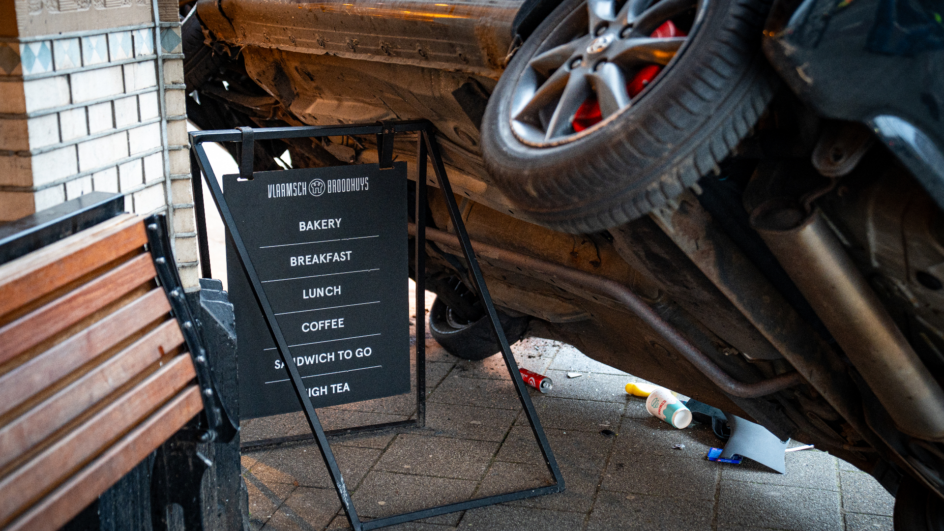 De auto kwam tot stilstand boven op een reclamebord van de bakkerij