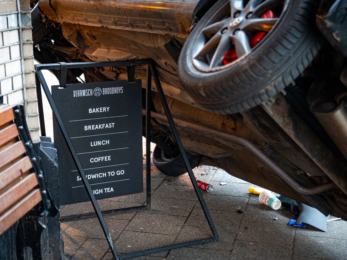 De auto kwam tot stilstand boven op een reclamebord van de bakkerij