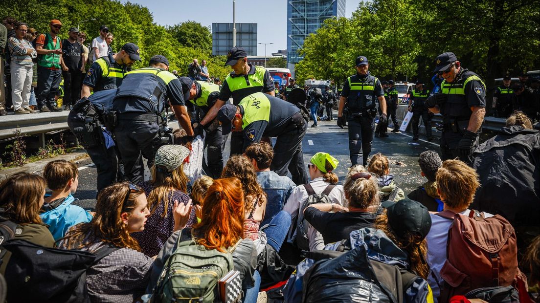 De politie arresteert klimaatactivisten op de A12