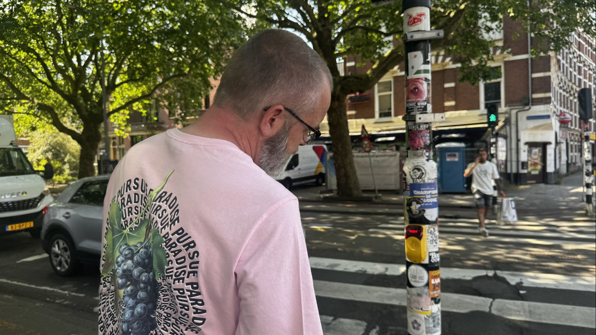 Richard observeert een lantaarnpaal met stickers.