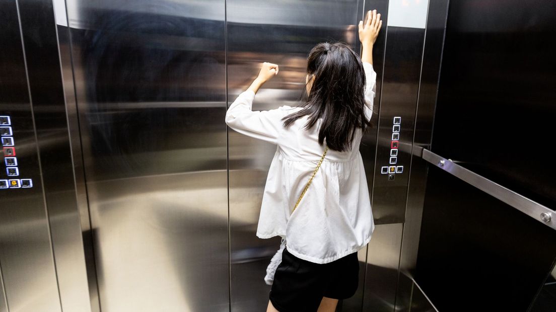 Een vrouw zit vast in de lift