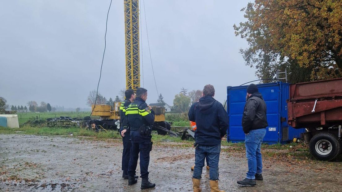 Politie op het terrein met op de achtergrond een deel van de zendmast