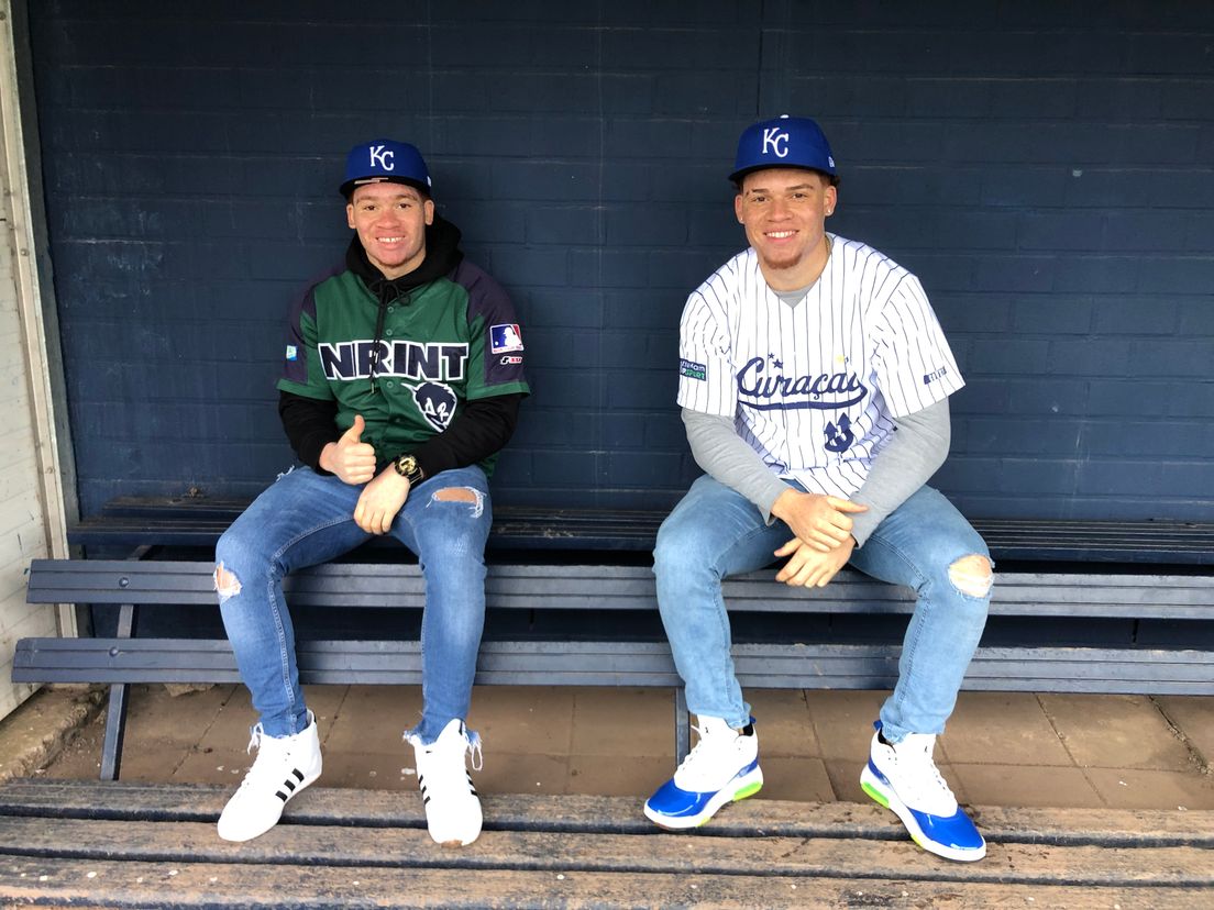 Darnel (17) en Darryl (19) Collins met de petten van hun nieuwe club: de Kansas City Royals.