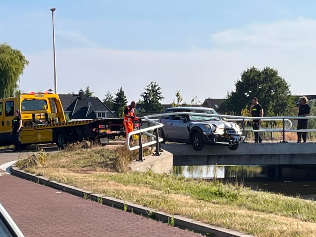 Een berger heeft de auto tussen de brugreling vandaan gehaald en afgesleept.