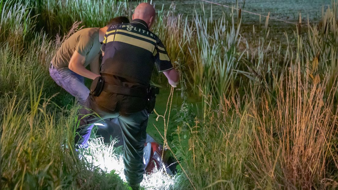 De scooter is uit de sloot gehaald, met flinke beschadiging.