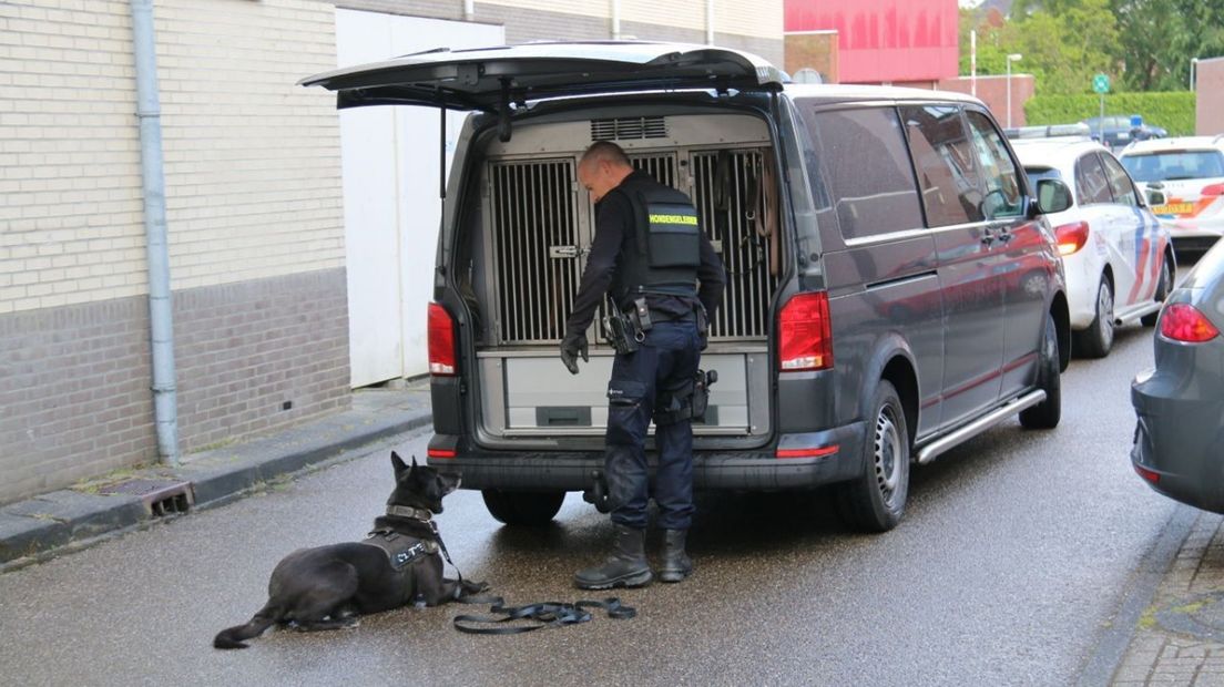 De hondengeleider met zijn speurhond