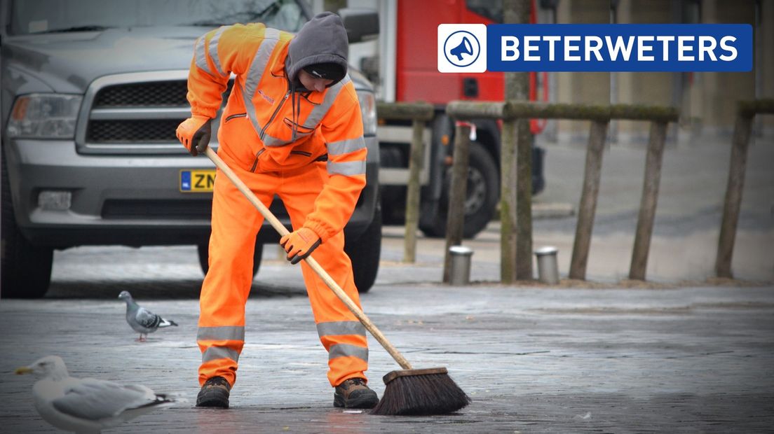 De straat wordt geveegd door een medewerker van de gemeente