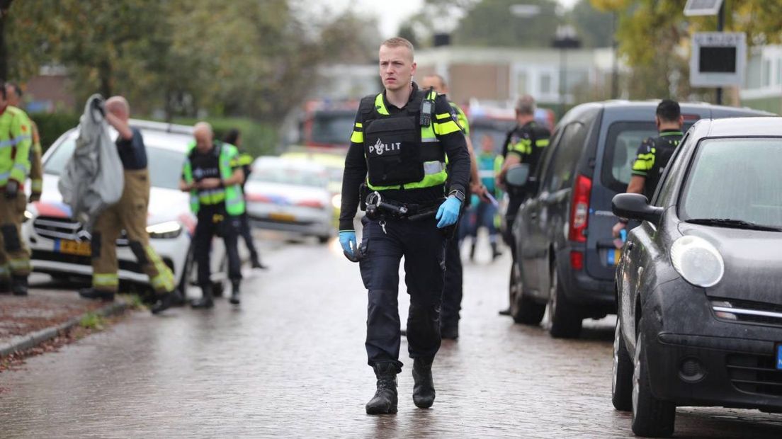 Een agent in de Apeldoornse Mauvestraat, na het dodelijke schietincident.